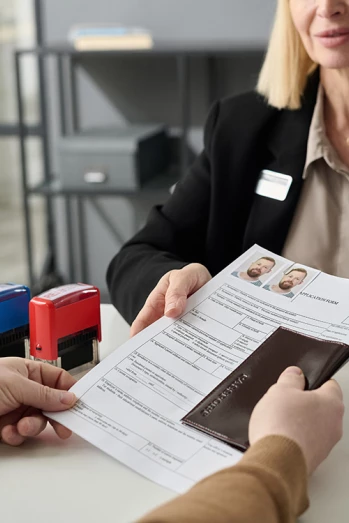 Man submitting work permit documentation
